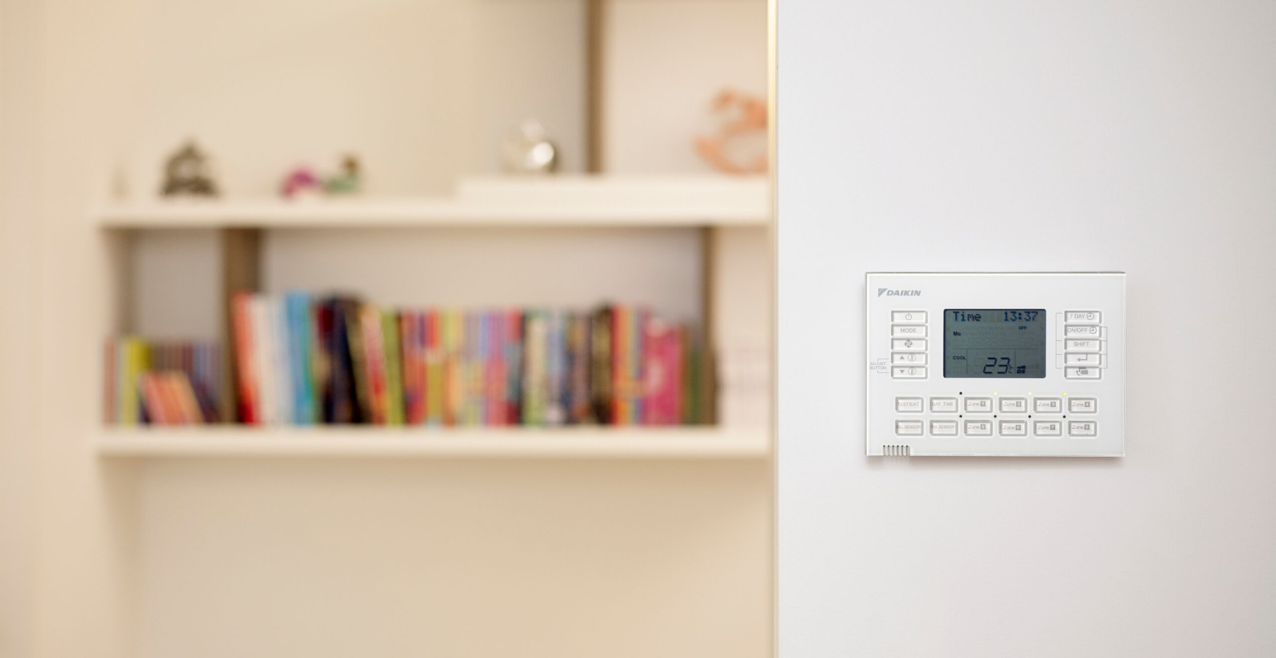Daikin wall controller and bookshelf on the Sunshine Coast, modern air conditioning control system