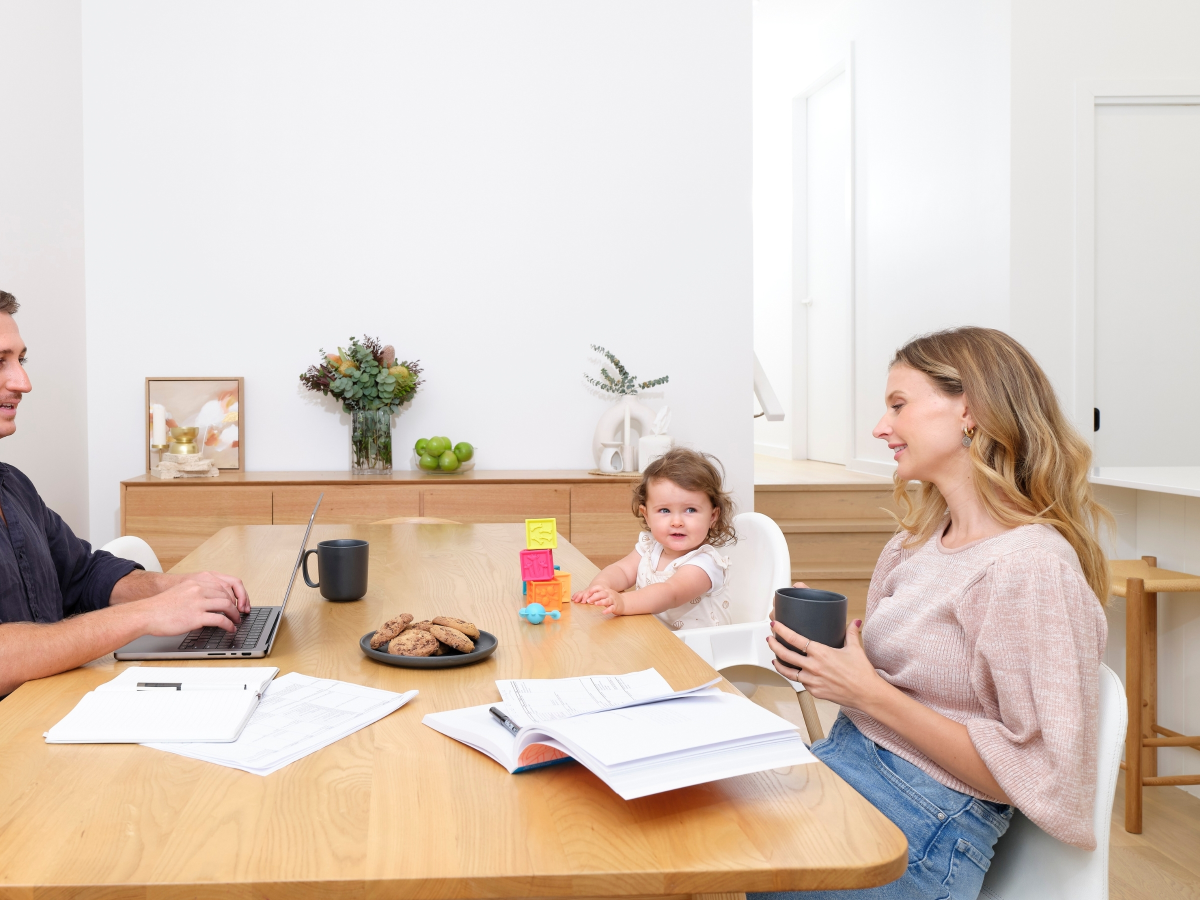 Happy family enjoying mealtime and working comfortably in Daikin cooled home Sunshine Coast