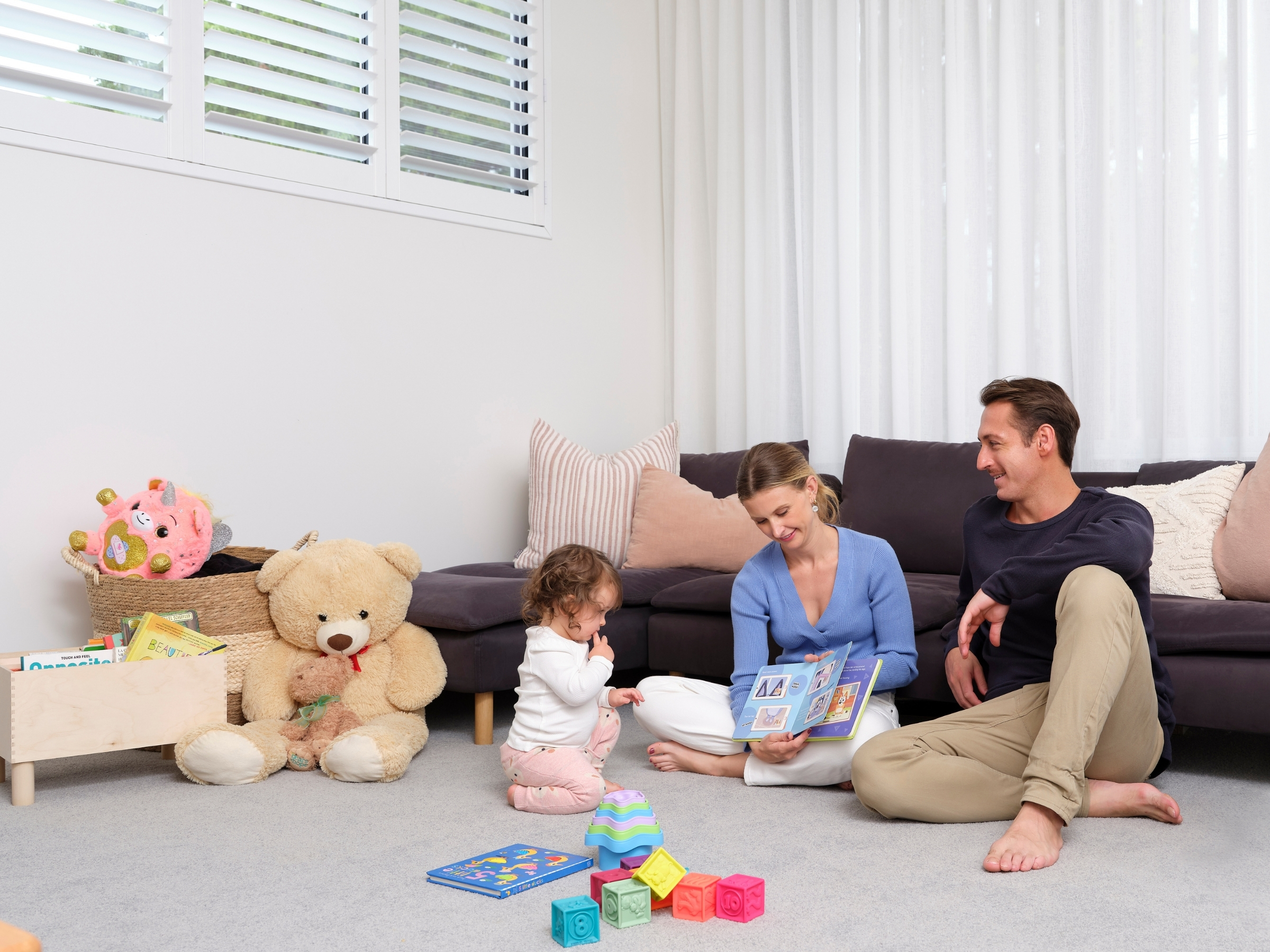 Father reading bedtime story to children in comfortable Daikin air conditioned bedroom Sunshine Coast