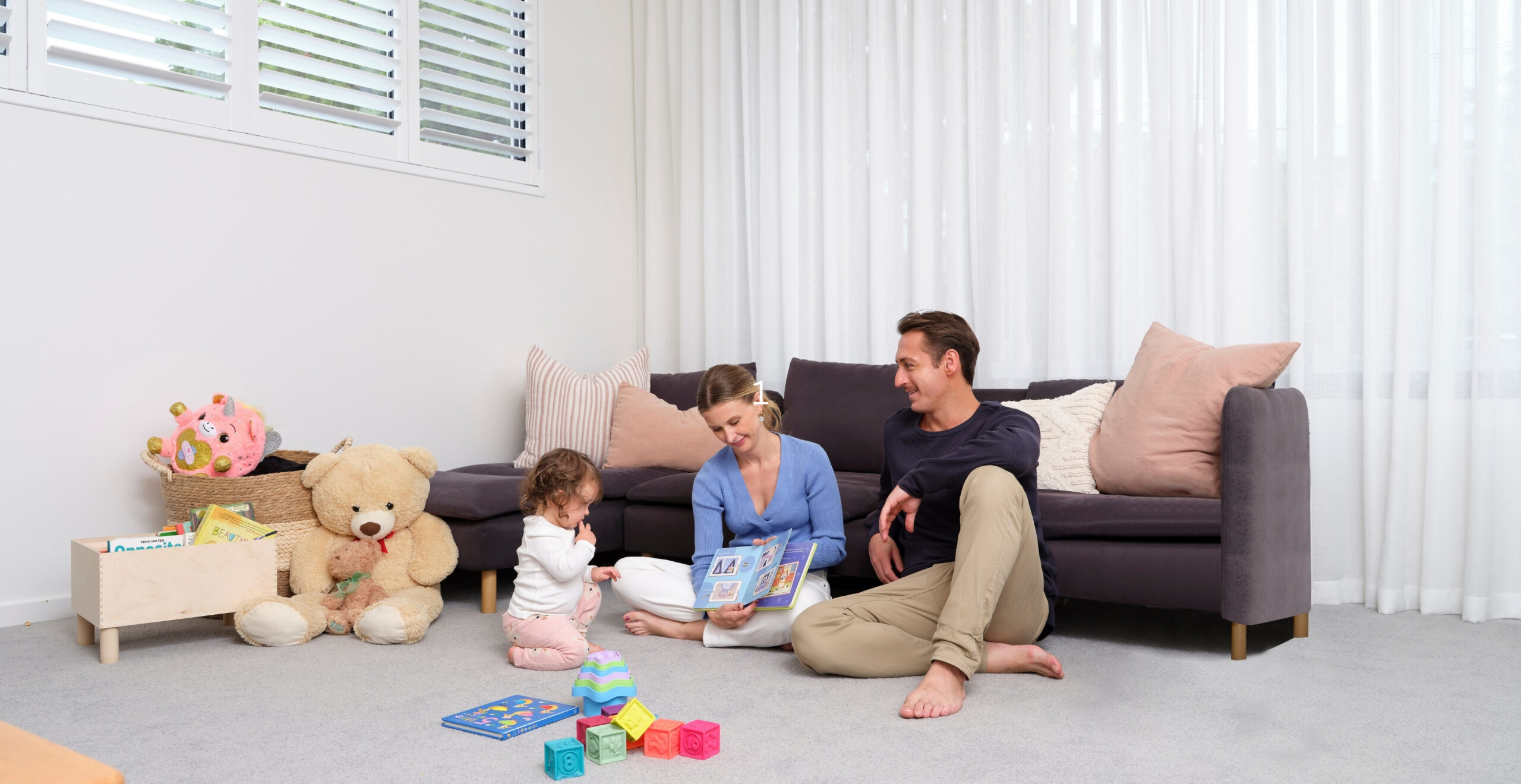 Family storytime with Daikin air conditioning comfort on the Sunshine Coast, reading together in climate-controlled home