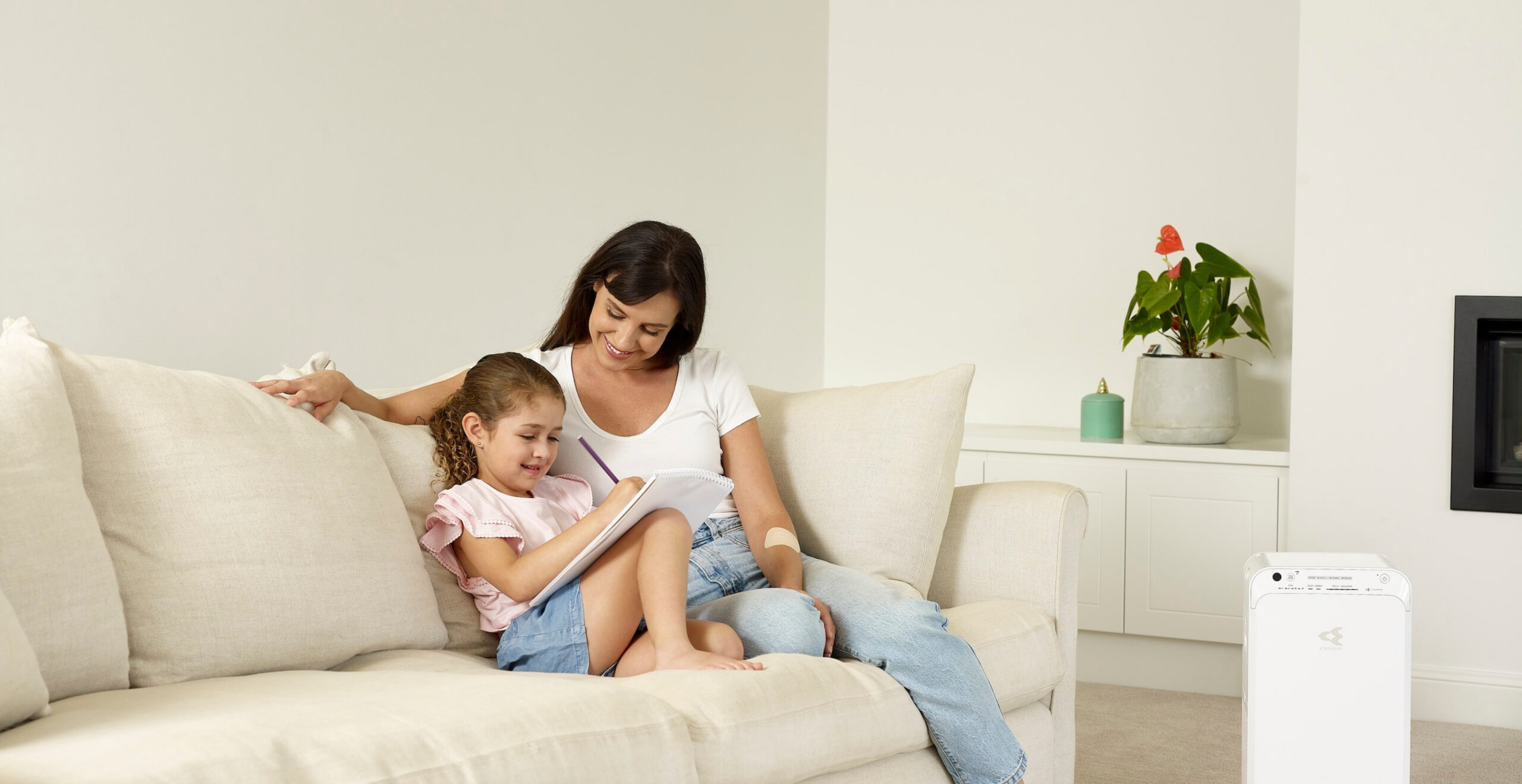 Mother and daughter reading with Daikin air purifier on the Sunshine Coast, enjoying clean air and comfort